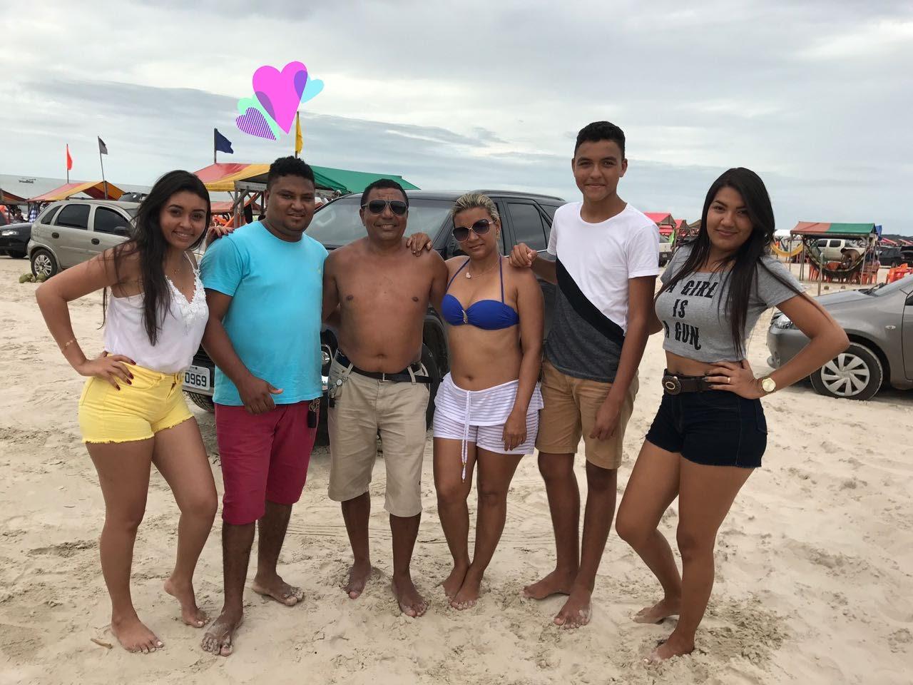 em momento de lazer na praia ao lado de esposa e filhos