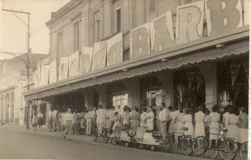 Liquidação da Casa Barbieri, loja de propriedade de Wilmon Barbieri. Araraquara, SP, década de 60. As pessoas faziam fila do lado de fora, algumas entravam e tinham 20 minutos para fazer as suas compras e sair para a entrada de outro grupo.