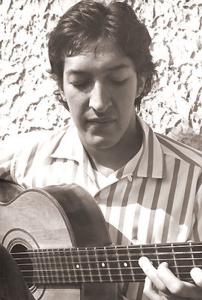 Toninho Horta com 15 anos, tocando violão na porta de sua casa.