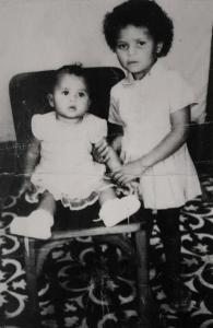 As irmãs Adriana e Marisa, ainda meninas em Pernambuco, lado a lado em um retrato cheio de ternura. Anos depois, já adultas, dividiram sonhos e desafios na Vila Esperança, em Cubatão. Naquele instante da infância, não podiam imaginar os caminhos que o futuro lhes preparava, mas a força do laço entre irmãs sempre esteve presente.