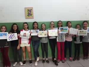 Alunos exibindo os desenhos de memória da entrevista com Dona Rosa