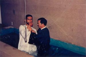 Antonio Dantas prestes a mergulhar na piscina de batismo. Converteu-se à religião da esposa após oito anos de casado. Foi batizado em um sábado à tarde na Igreja Adventista de Sétimo Dia. Esq.-Dir.: Antonio Dantas e Pastor Lamarques.